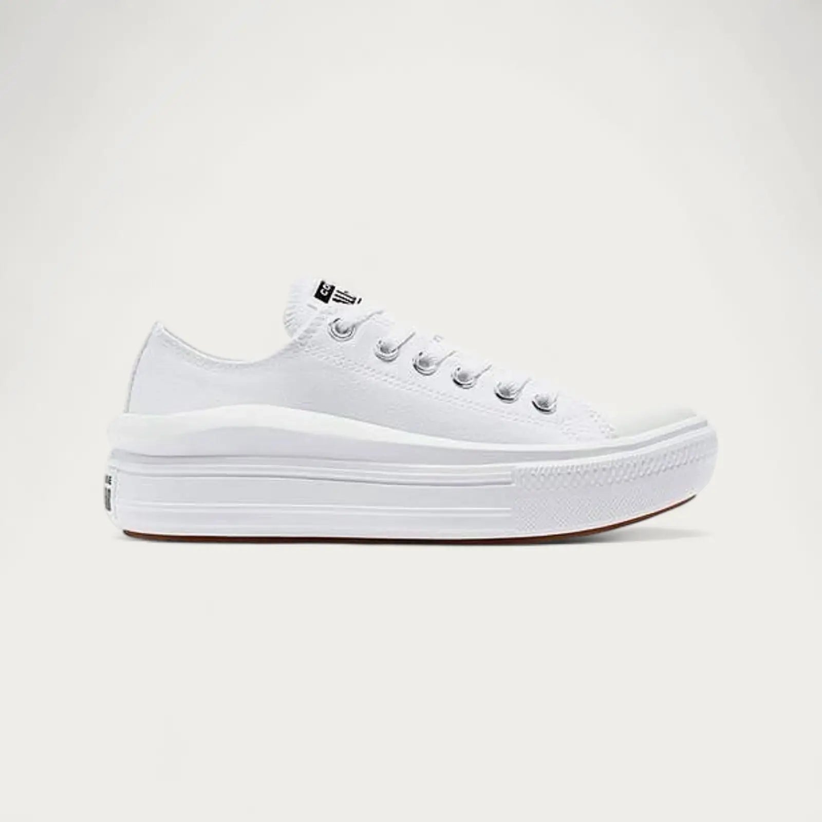 White sneaker with a platform sole on a light gray background